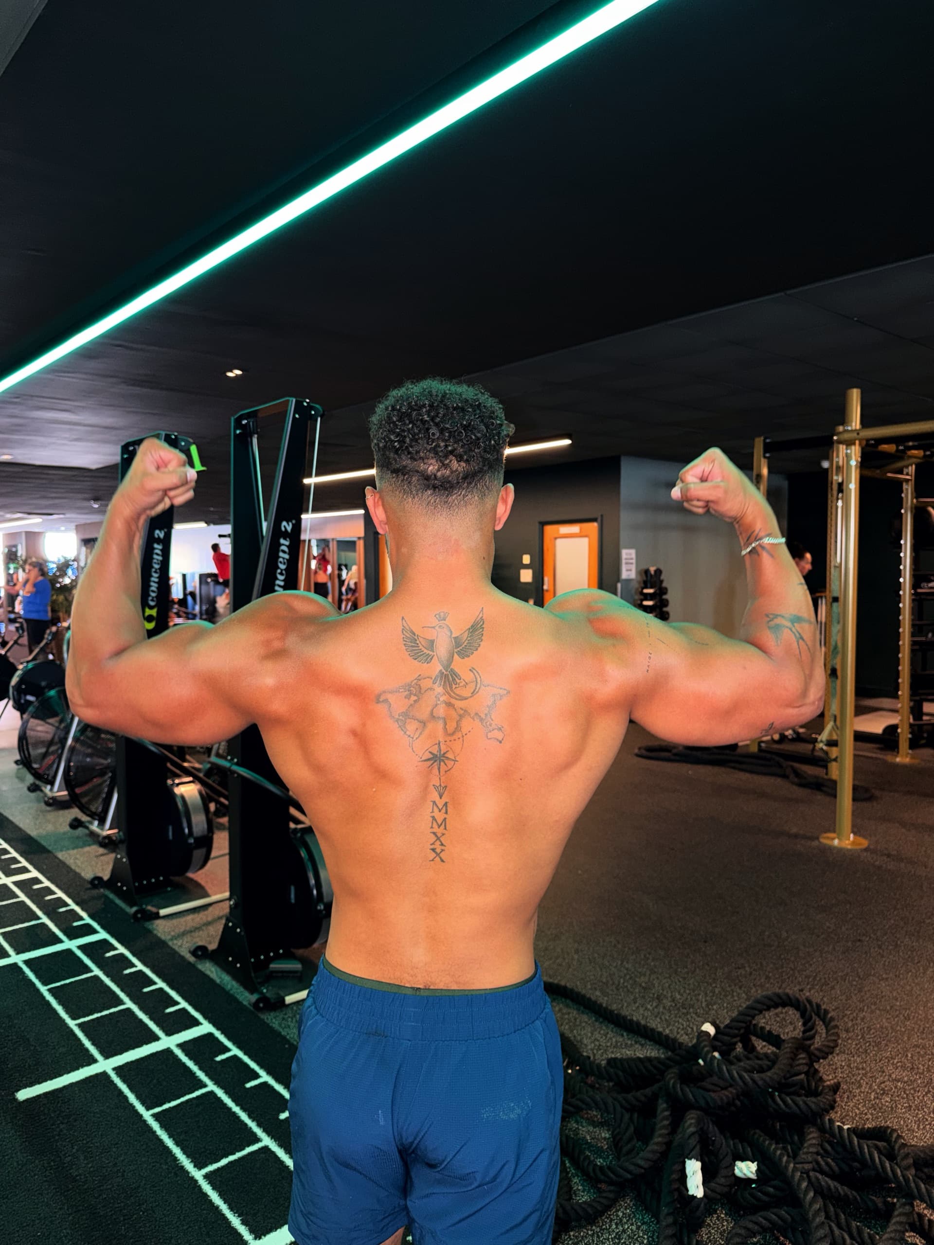 Cole Anderson James from behind, hitting a back double biceps